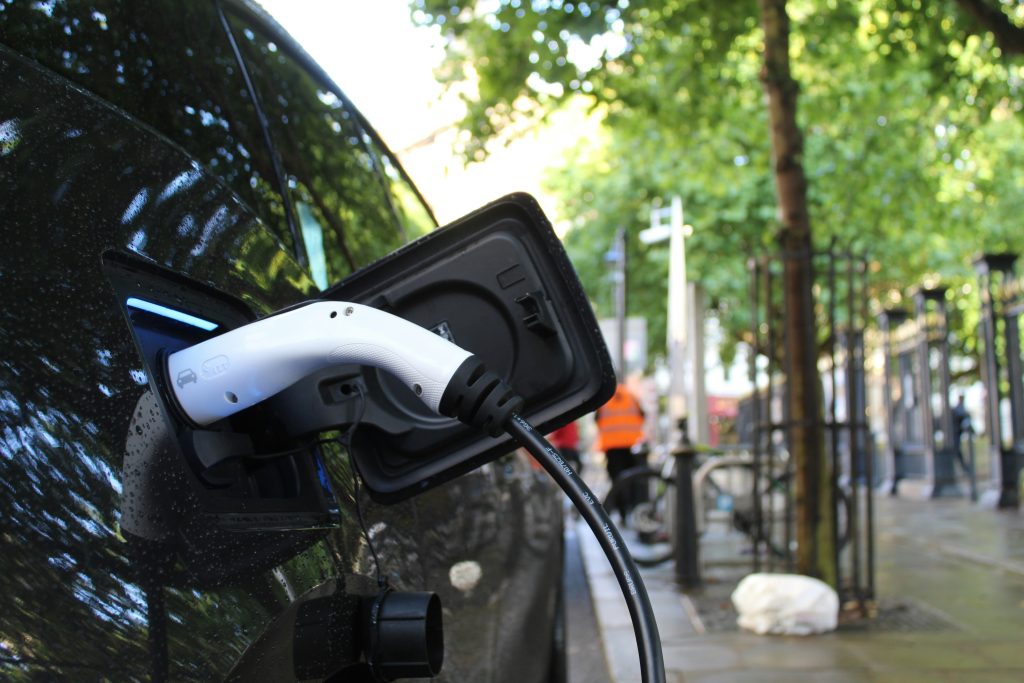 An electric vehicle is charging on the roadside.