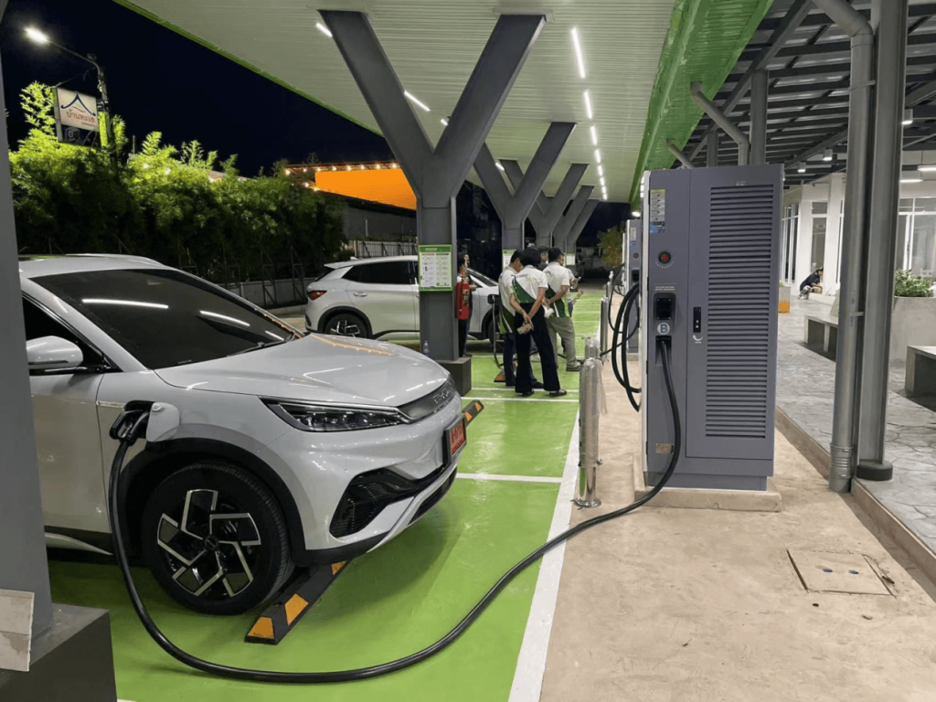 An electric car charging at a public electric car charging station